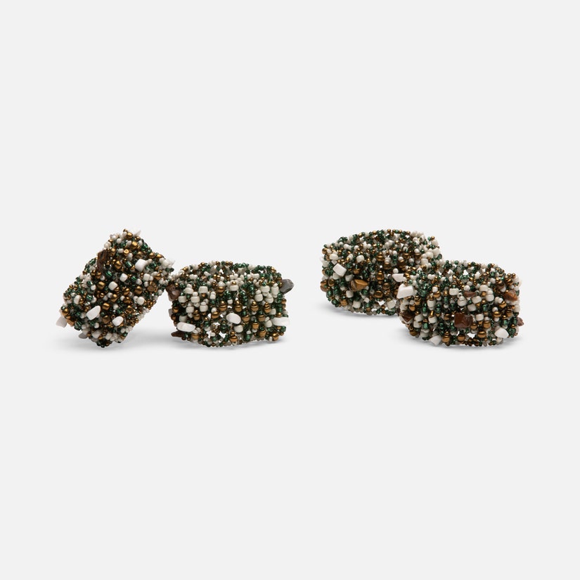 Fianna Napkin Rings in Emerald Mix, set of 4 with a sunburst shape made from mixed glass beads. Flexible design fits any napkin size. Easy to clean with a damp cloth.
