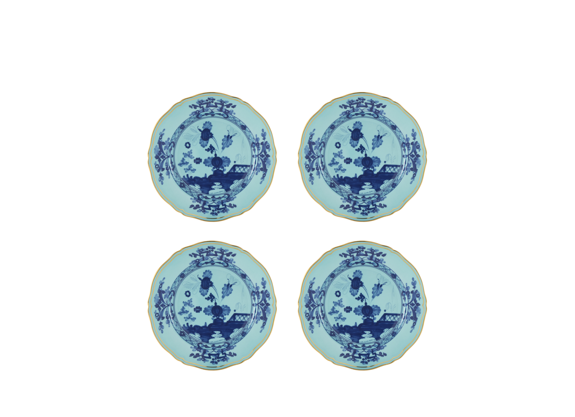 Set of four Iris dessert plates from the Oriente Italiano collection, featuring blue carnation motifs on iris blue porcelain with gold threading that outlines the Antico Doccia shape.