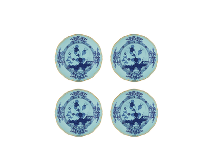 Set of four Iris dessert plates from the Oriente Italiano collection, featuring blue carnation motifs on iris blue porcelain with gold threading that outlines the Antico Doccia shape.