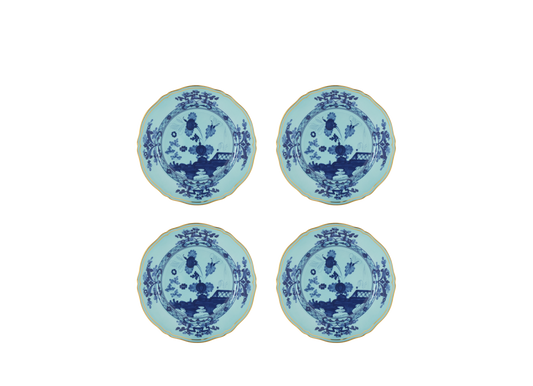 Set of four Iris dessert plates from the Oriente Italiano collection, featuring blue carnation motifs on iris blue porcelain with gold threading that outlines the Antico Doccia shape.