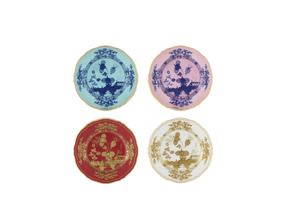 Set of four porcelain dessert plates from the Oriente Italiano collection, featuring gold threading and the Iris, Azalea, Rubrum, and Aurum designs. The plates showcase a signature carnation motif in contrasting tones with delicate hand-painted gold details