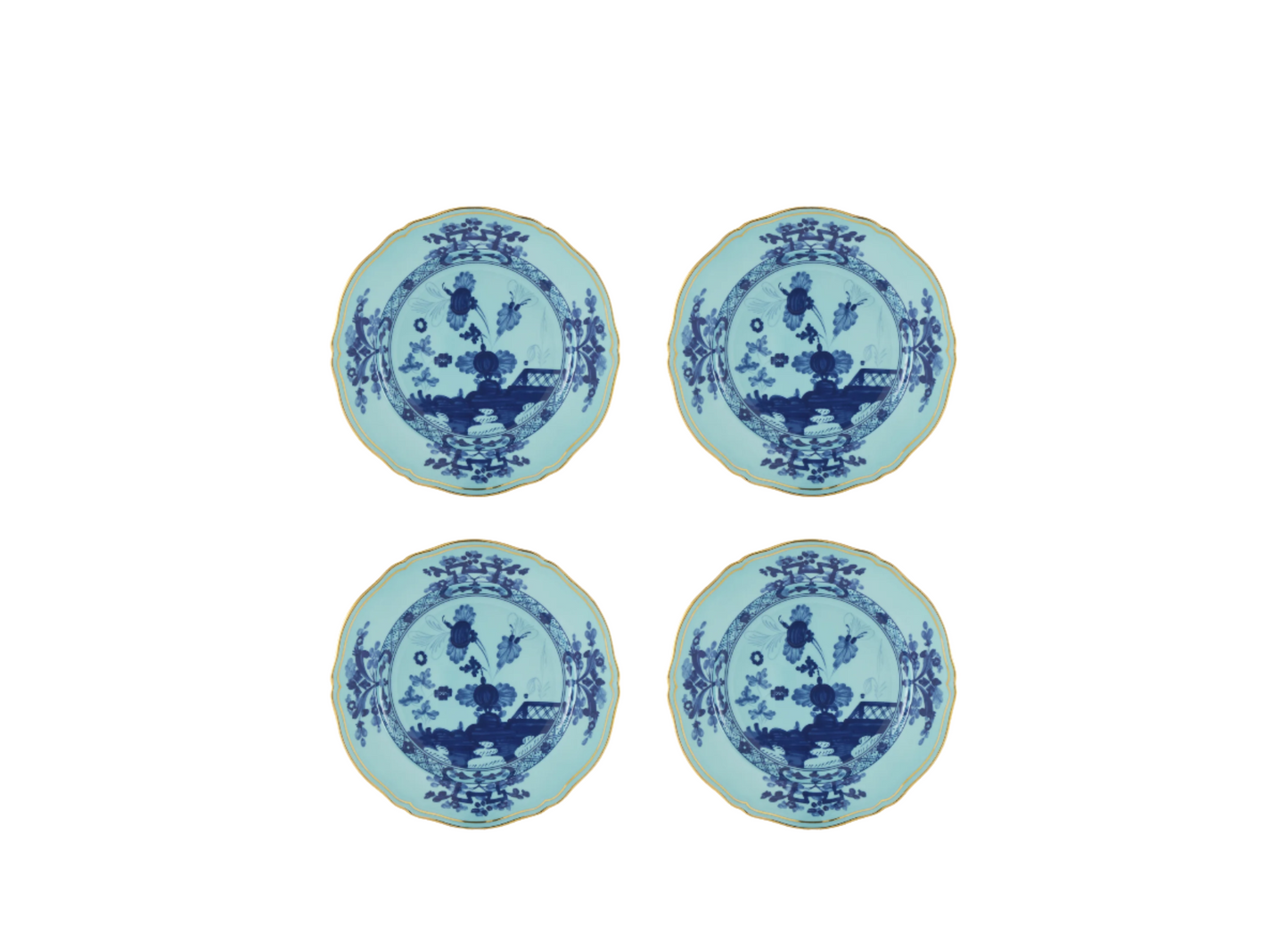 Set of four Iris dessert plates from the Oriente Italiano collection, featuring blue carnation motifs on iris blue porcelain with gold threading that outlines the Antico Doccia shape.