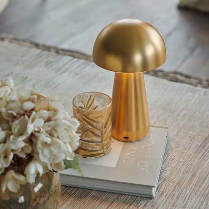 Golden cordless LED lamp with touch dimming and rechargeable battery, perfect for adding a warm, cozy glow to any room. Features a smooth metallic gold finish and modern dome design.