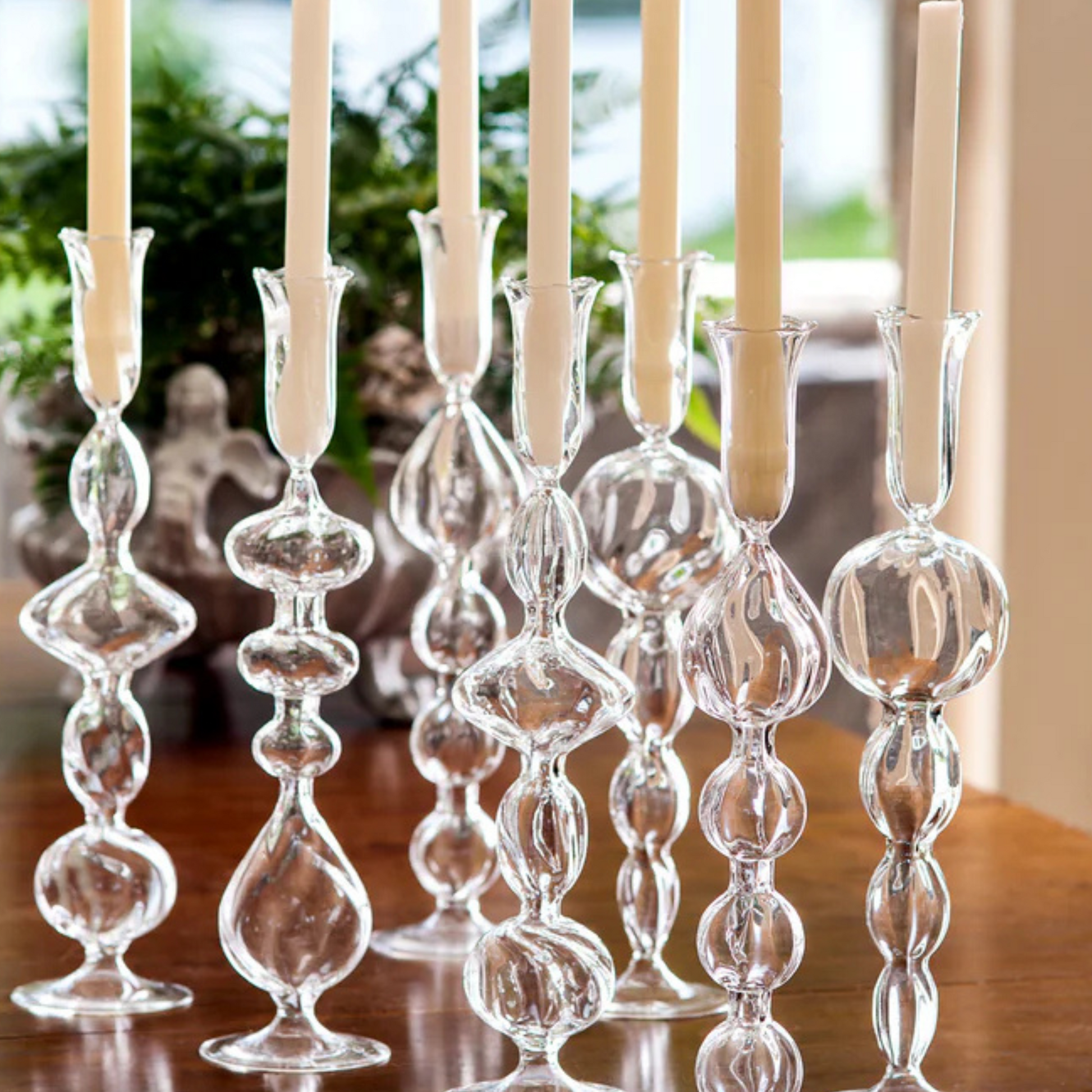 Clear Glass Candlestick with a unique handcrafted teardrop effect, perfect for adding a touch of luxury and warm candlelight to any setting.