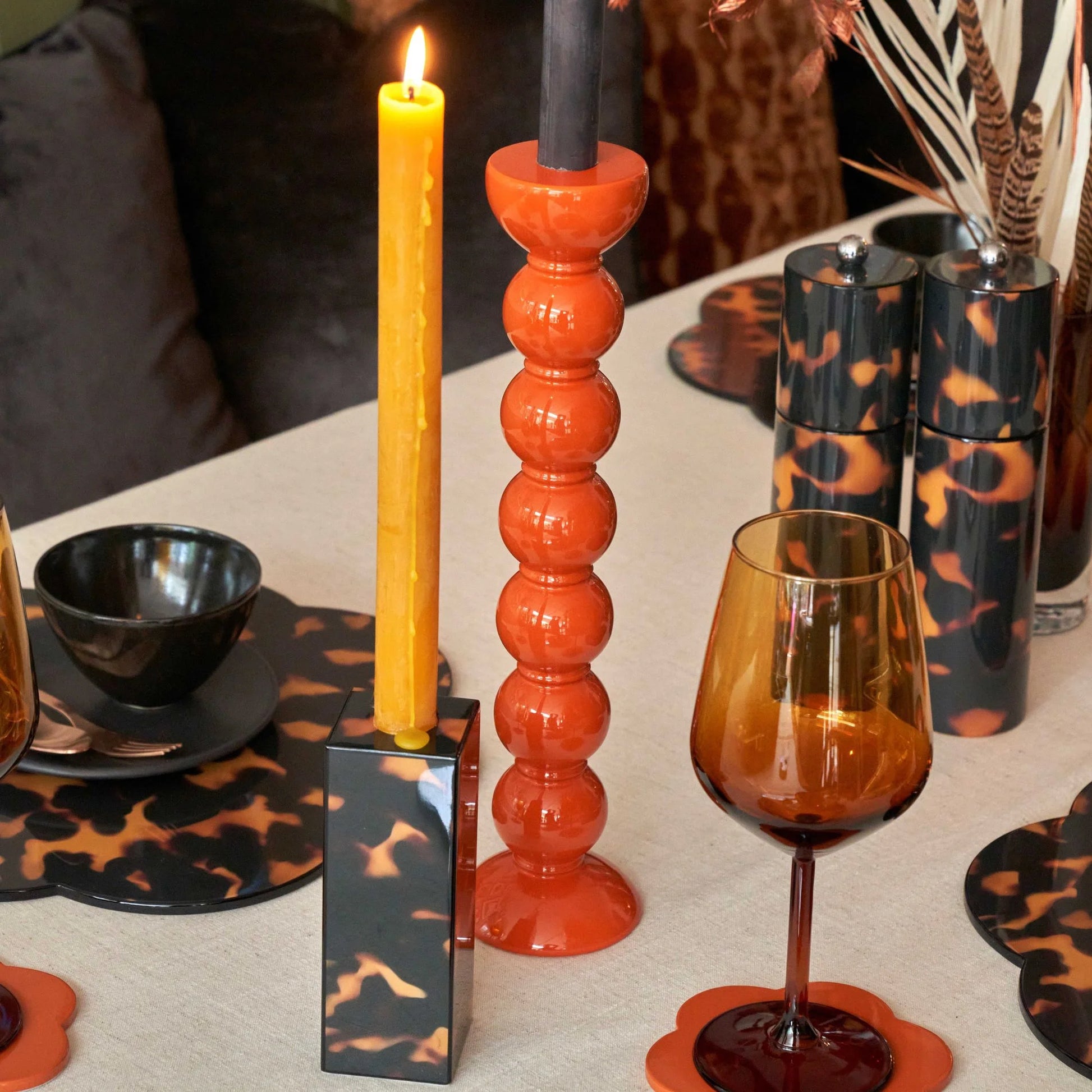 Medium faux tortoise shell lacquered bobbin-shaped candlestick made from FSC-certified rubber wood with a glossy, hand-polished finish, designed for standard dinner candles.