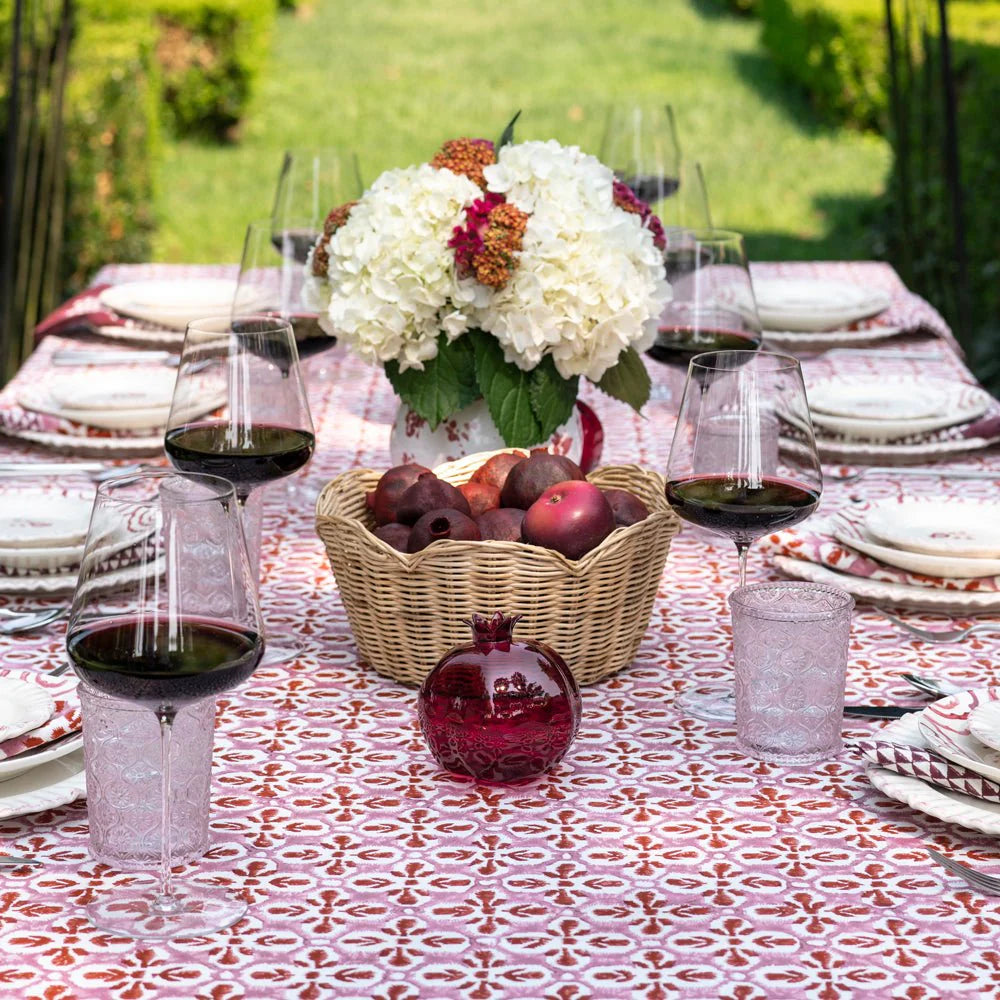 Fleur de Lis Rose Tablecloth with a soft pink pattern and bold purple border, hand-block printed on 100% cotton. Perfect for adding elegance to your dining table. Measures 60" x 120".