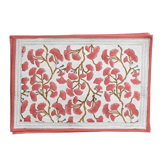 Set of Ginkgo Coral Placemats featuring a hand block printed coral ginkgo leaf design on soft cotton canvas. Made from 100% cotton, these placemats are machine washable and measure 13" x 19". Ideal for both casual and formal dining. Made in India.