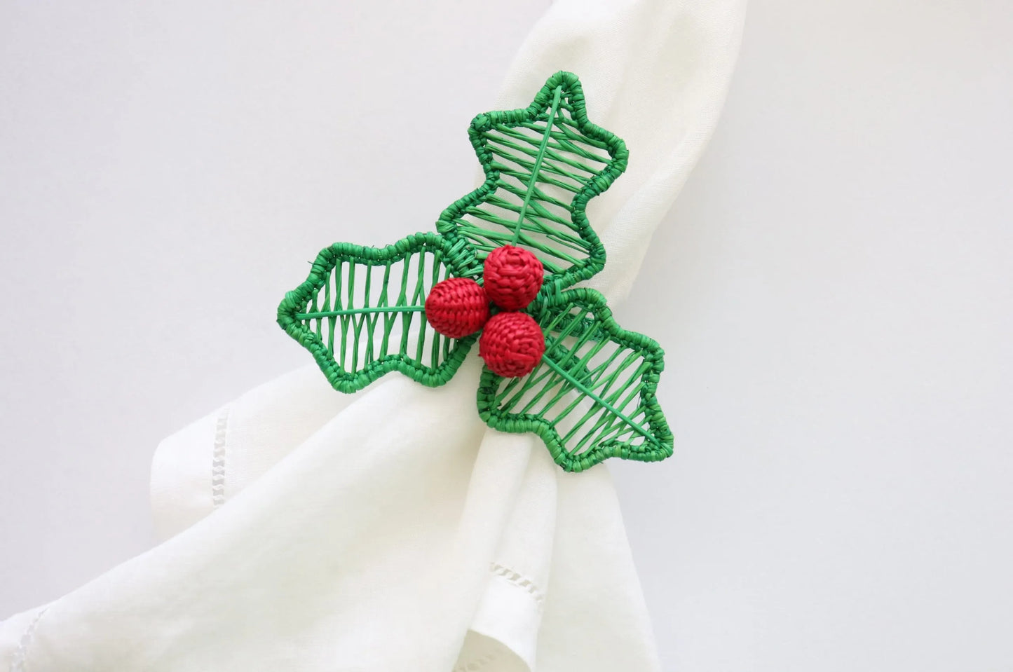 Holly Berry Napkin Ring, handwoven from Iraca Palm in Colombia, adds a charming and handcrafted touch to your table decor. Measures 3" x 3", and should be cleaned with a damp cloth or toothbrush.