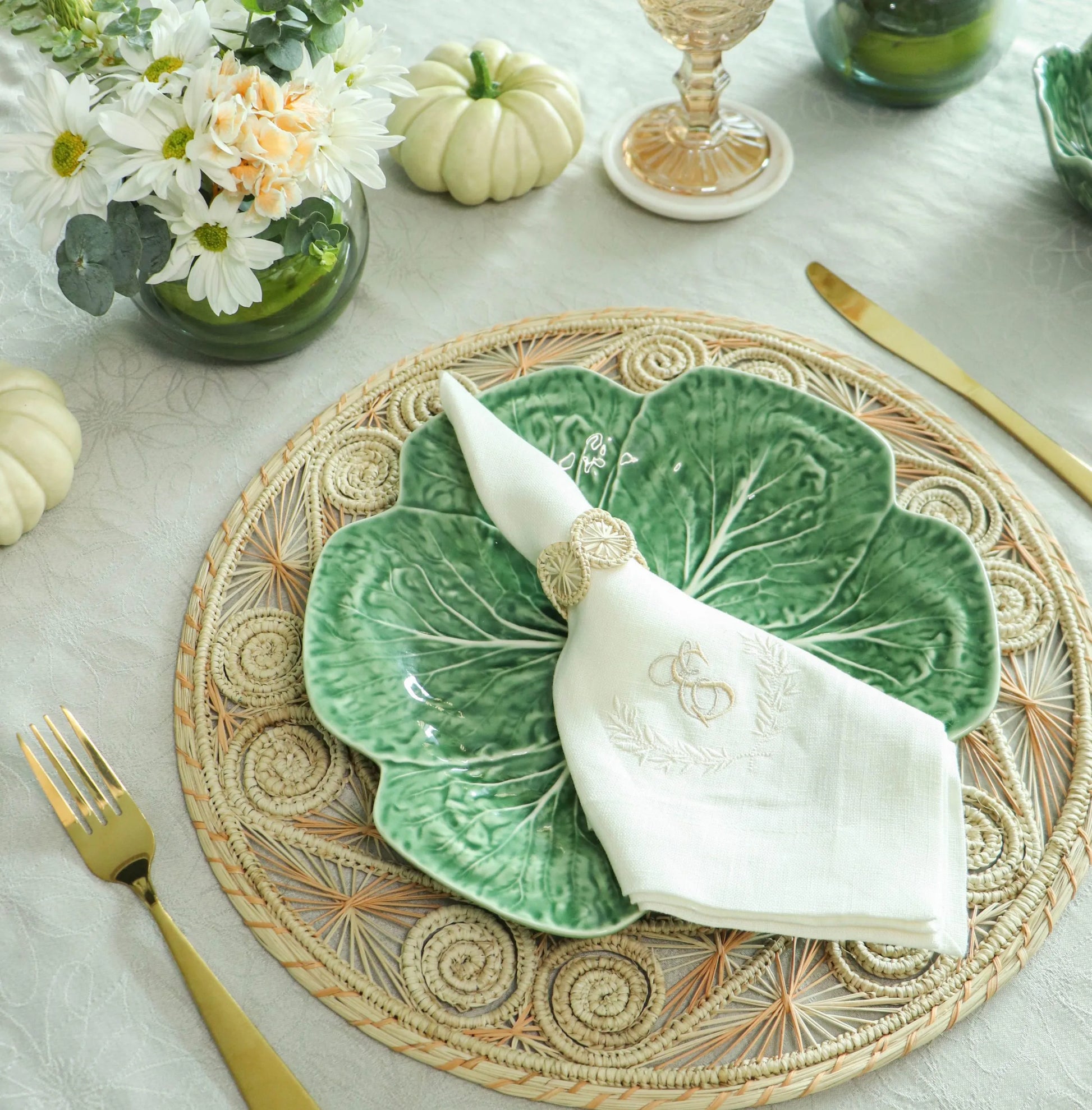 Swirl Napkin Ring, handwoven from Iraca Palm and wire by skilled artisans in Colombia. This piece adds a natural touch to your table. Clean with a damp cloth or toothbrush for best care.