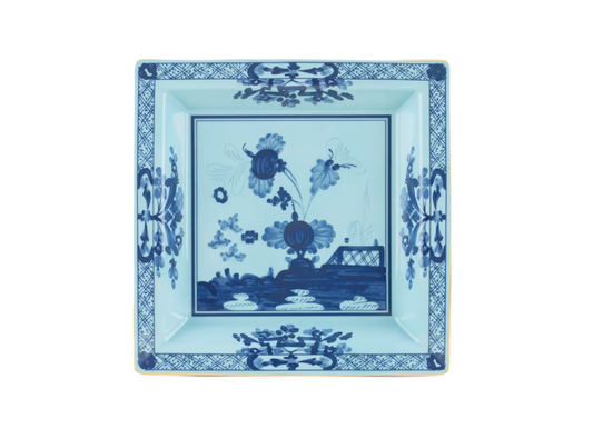 Iris square change tray in porcelain with gold threading from the Oriente Italiano collection. Features a contrasting blue carnation floral motif against iris blue porcelain with gold threading along the Antico Doccia shape.