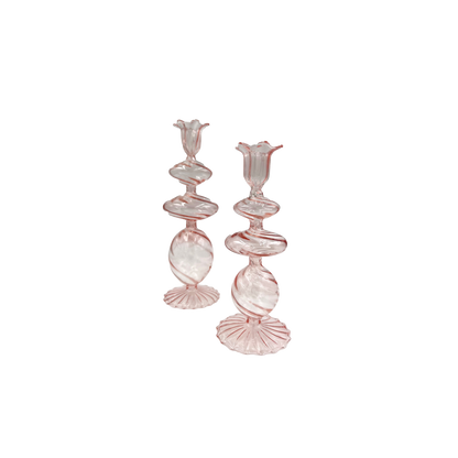 Charming pink candlesticks made from mouth-blown borosilicate glass, perfect for adding a stylish touch to any dining table.