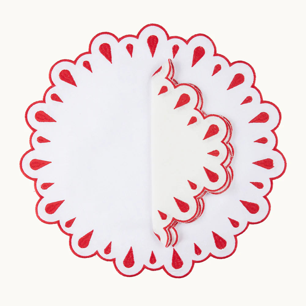 A set of 4 white linen napkins adorned with red embroidery and scalloped edges, designed to elevate any table setting with elegance and charm.