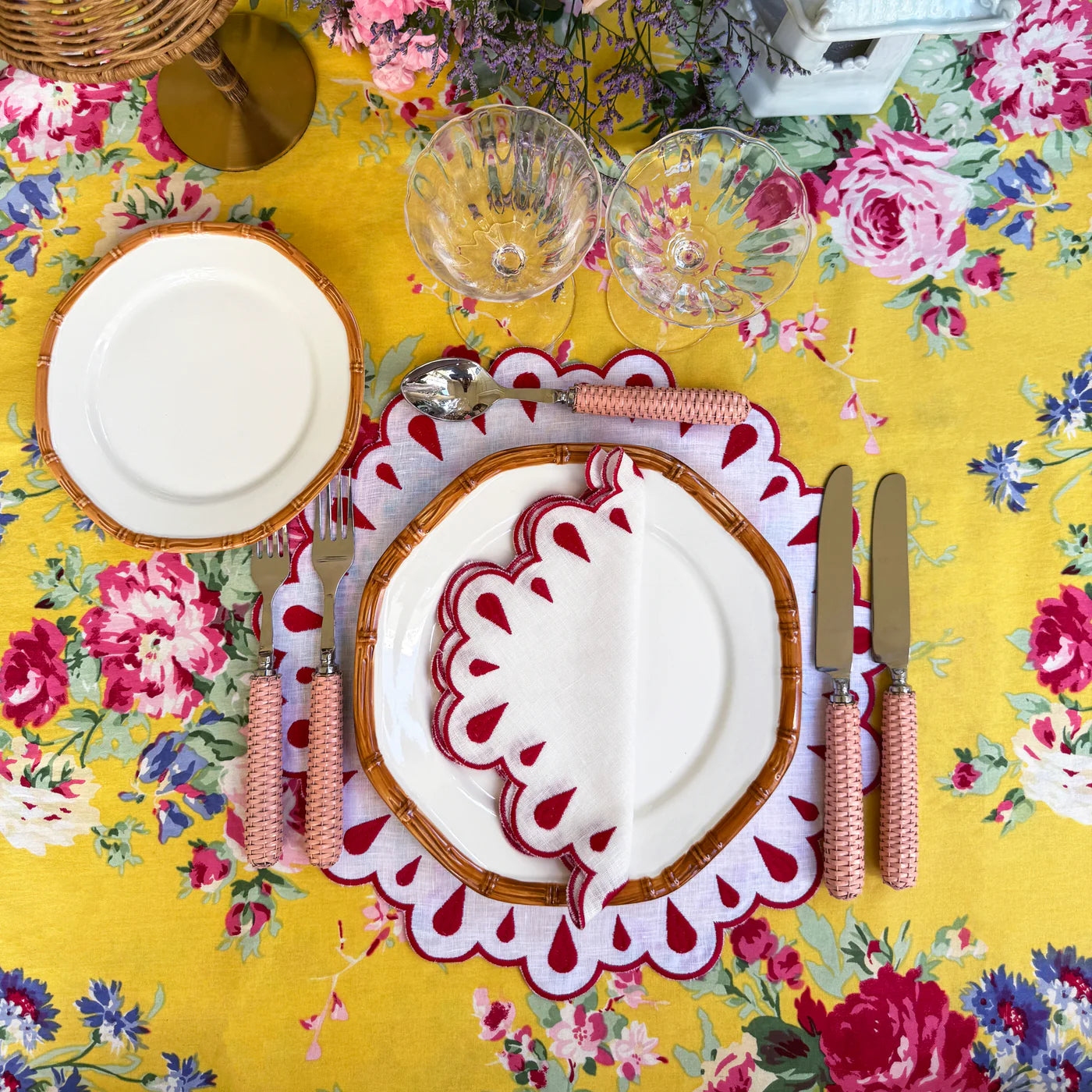 A set of 4 white linen napkins adorned with red embroidery and scalloped edges, designed to elevate any table setting with elegance and charm.