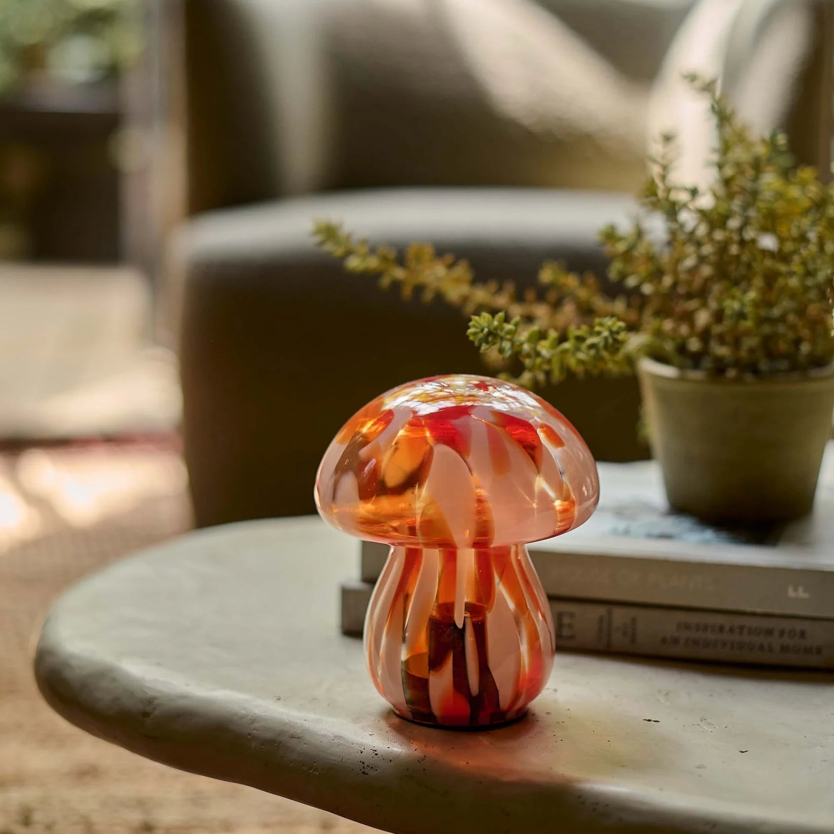 Cordless LED lamp with a marbled pink and orange glass mushroom design, ideal for lighting dark corners, coffee tables, or bedside tables. Sculptural and battery-operated for flexible styling options around the home.