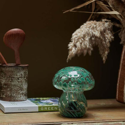 Cordless LED lamp with an earthy forest green glass mushroom design, ideal for lighting dark corners, coffee tables, or bedside tables. Sculptural and battery-operated for flexible styling options around the home.