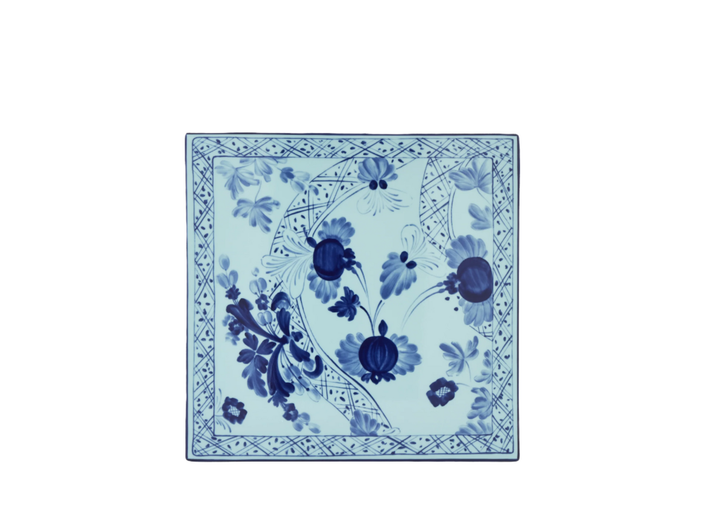 Set of 2 square porcelain placemats in Iris from the Oriente Italiano collection, featuring a blue floral pattern on an iris blue background with gold threading accents.