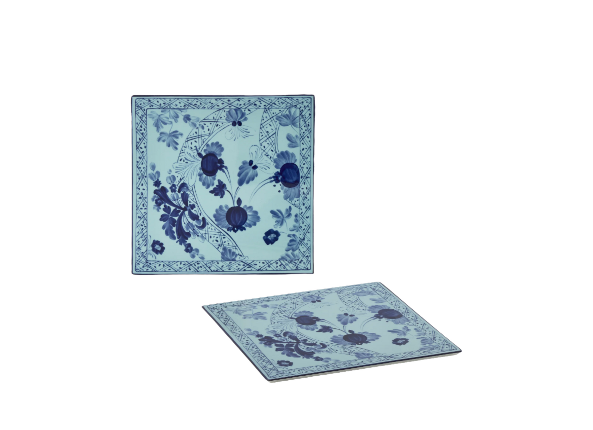 Set of 2 square porcelain placemats in Iris from the Oriente Italiano collection, featuring a blue floral pattern on an iris blue background with gold threading accents.