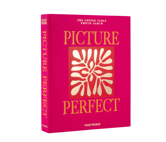 Picture Perfect Coffee Table Photo Album with a cerise cloth cover and orange text, containing 30 black photo paper pages for two 10x15 cm photos per page, with space for personal notes.