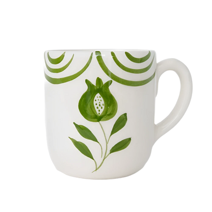 Set of 2 Pomegranate Crest Green Mugs featuring a bold hand-painted pomegranate design with delicate green arcs. Made from 100% ceramic, these mugs are microwave and dishwasher safe. Perfect for coffee, tea, or hot chocolate. Made in Portugal.