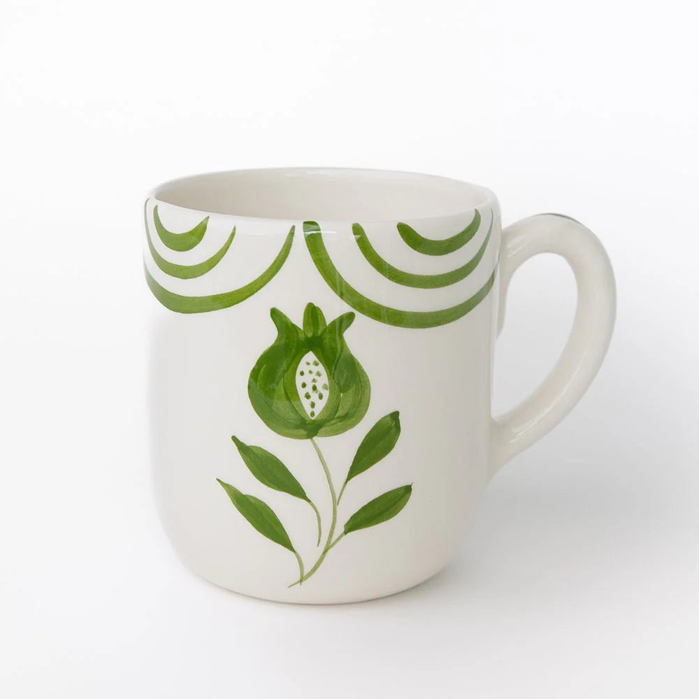 Set of 2 Pomegranate Crest Green Mugs featuring a bold hand-painted pomegranate design with delicate green arcs. Made from 100% ceramic, these mugs are microwave and dishwasher safe. Perfect for coffee, tea, or hot chocolate. Made in Portugal.