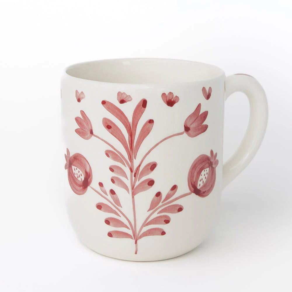 Set of 2 Pomegranate Duet Rose Mugs featuring hand-painted pomegranate designs and soft floral elements in rose pink. Each mug is 100% ceramic, microwave and dishwasher safe. Perfect for enjoying tea, coffee, or hot cocoa. Made in Portugal