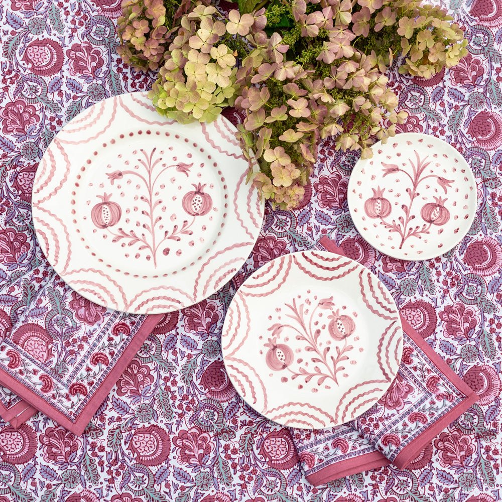 Set of 2 Duet Rose Salad Plates, hand-painted with intricate rosy pink pomegranate and floral designs. Made from 100% ceramic, these elegant plates are microwave and dishwasher safe. Each plate measures 8.25" in diameter, made in Portugal.