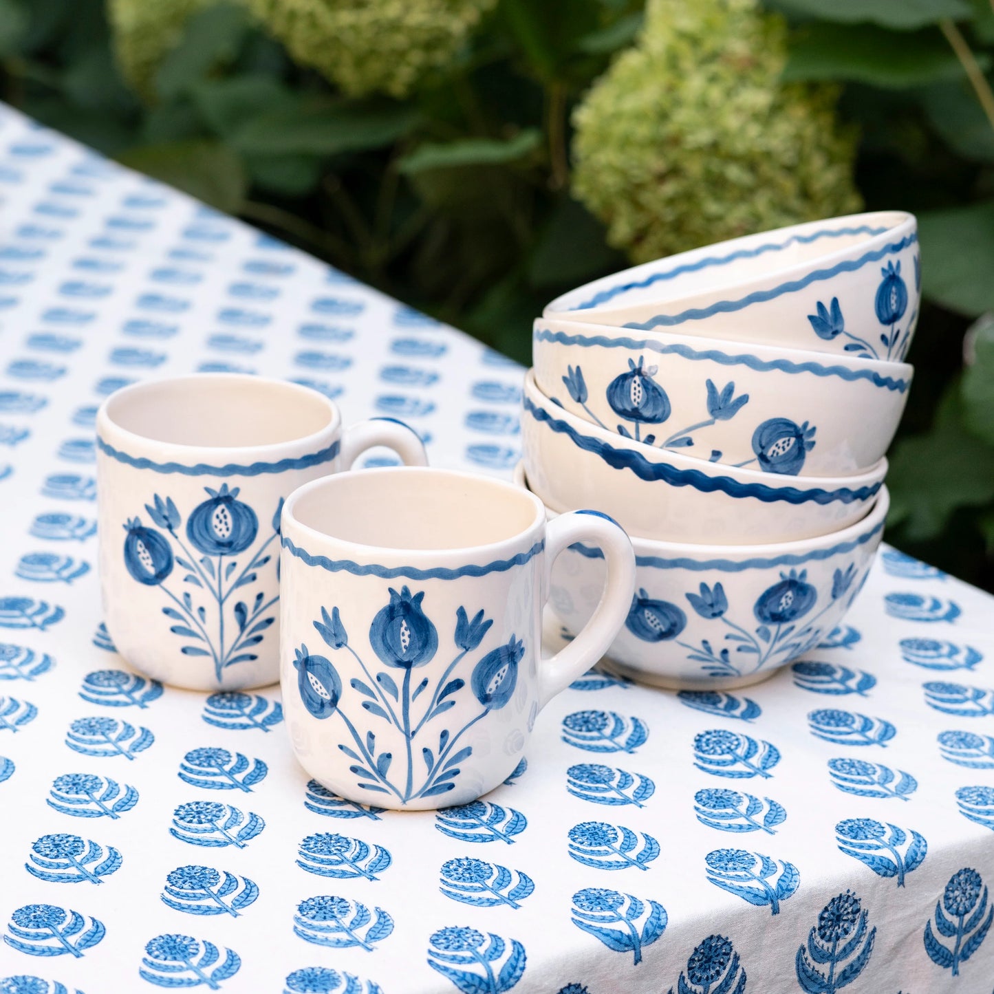 Set of 2 Pomegranate Trio Sketch Cobalt Blue Mugs featuring vibrant hand-painted pomegranates in rich cobalt blue. Made from 100% ceramic, these mugs are microwave and dishwasher safe. Perfect for enjoying coffee, tea, or hot chocolate. Made in Portugal.