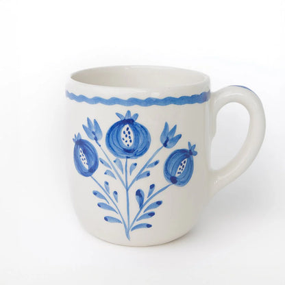 Set of 2 Pomegranate Trio Sketch Cobalt Blue Mugs featuring vibrant hand-painted pomegranates in rich cobalt blue. Made from 100% ceramic, these mugs are microwave and dishwasher safe. Perfect for enjoying coffee, tea, or hot chocolate. Made in Portugal.