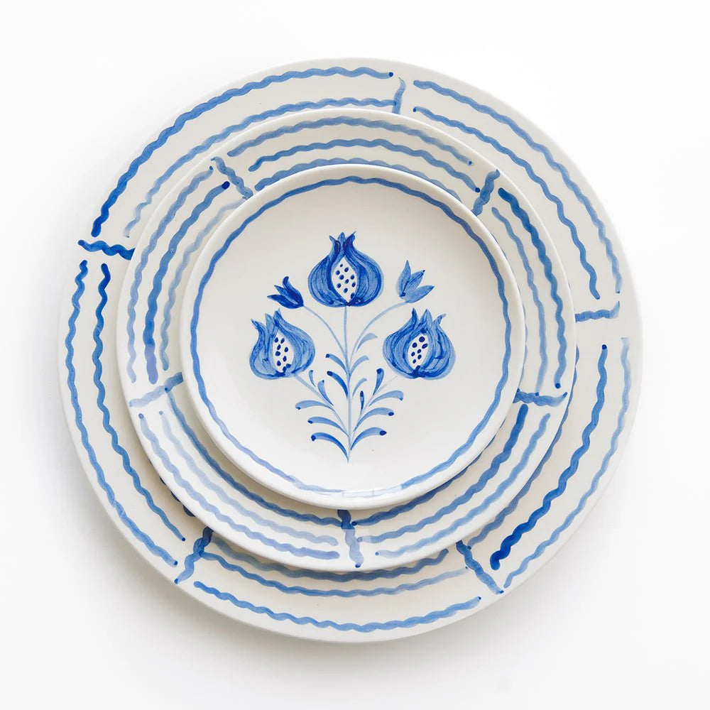 Set of 2 hand-painted Pomegranate Trio Sketch Cobalt Blue Salad Plates featuring intricate pomegranate designs framed by decorative blue lines. Made from 100% ceramic, microwave and dishwasher safe. Each plate measures 8.25" in diameter. Crafted in Portugal.