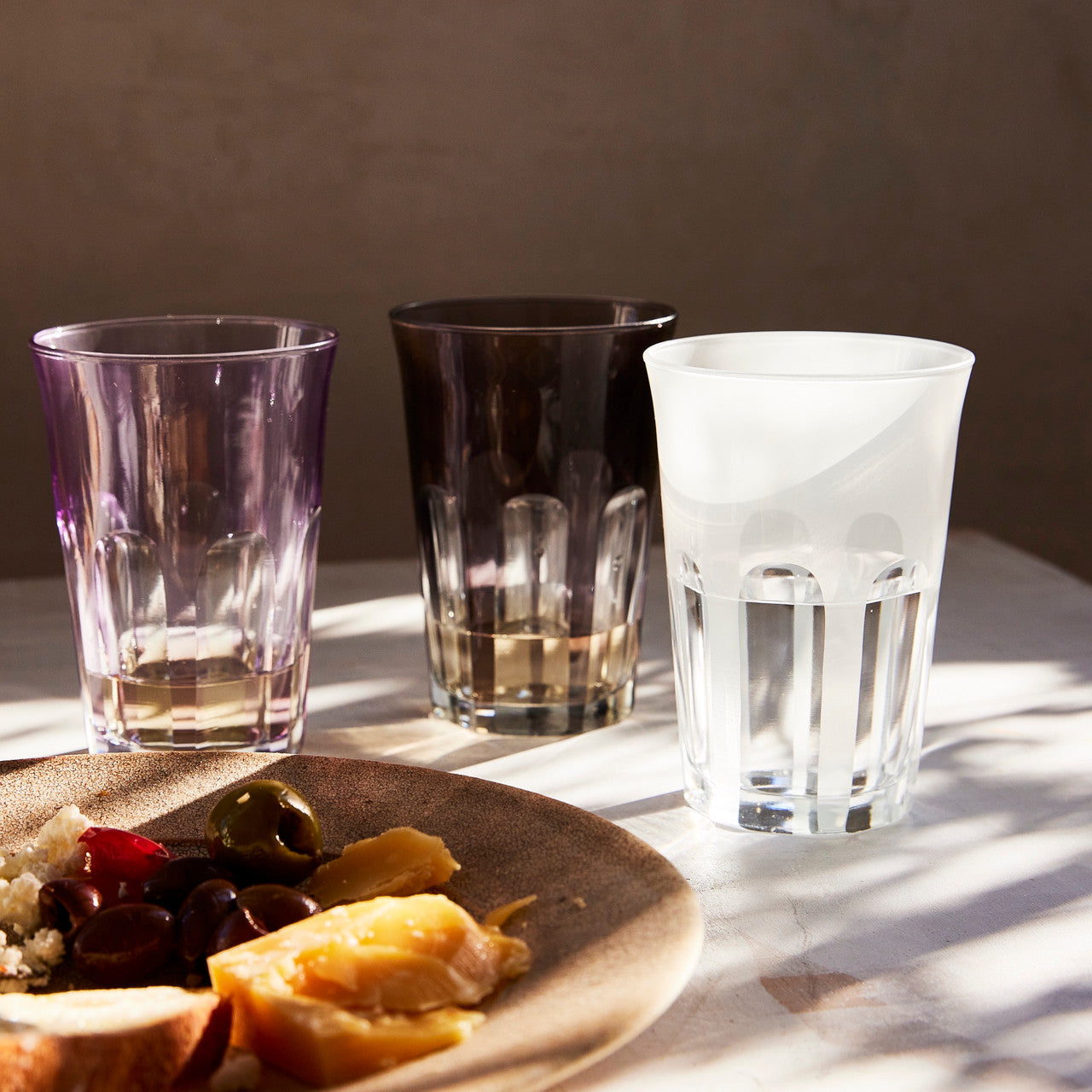 Rialto Tumbler in Smoke, set of 2 drinking glasses inspired by Venice's Rialto Bridge. Handcrafted in Turkey, each tumbler features unique color and cutwork. Perfect for water or wine. Hand-wash with a soft cloth and soapy water.