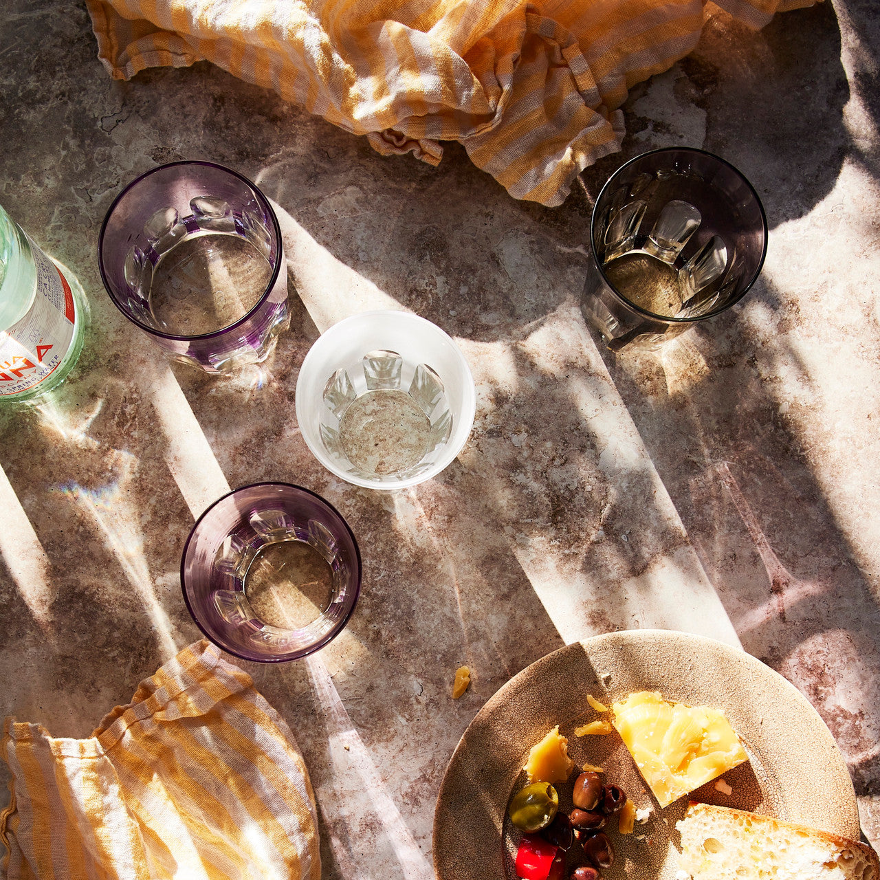 Rialto Tumbler in Smoke, set of 2 drinking glasses inspired by Venice's Rialto Bridge. Handcrafted in Turkey, each tumbler features unique color and cutwork. Perfect for water or wine. Hand-wash with a soft cloth and soapy water.