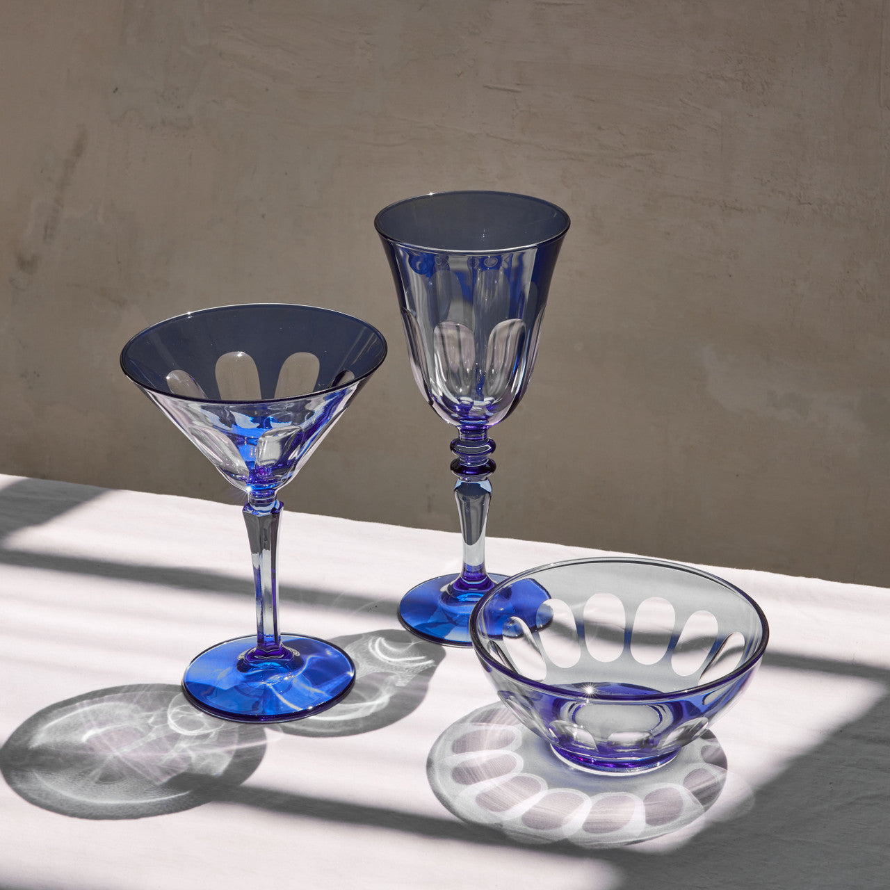 Rialto Wine Glass, set of 2, inspired by Venice's Rialto Bridge. Handcrafted in Turkey, each glass features unique color and cutwork. Holds 9 oz and perfect for adding a festive touch to your table. Hand-wash with a soft cloth and soapy water.