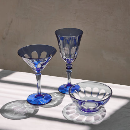 Rialto Wine Glass, set of 2, inspired by Venice's Rialto Bridge. Handcrafted in Turkey, each glass features unique color and cutwork. Holds 9 oz and perfect for adding a festive touch to your table. Hand-wash with a soft cloth and soapy water.