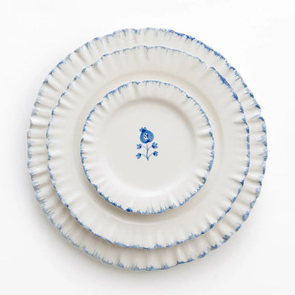 Set of 4 Ruffled Cobalt Blue Appetizer Plates with hand-painted cobalt blue trim and ruffled edges. Each plate measures 5.5" in diameter, ideal for appetizers or small bites. Microwave and dishwasher safe. Made in Portugal.