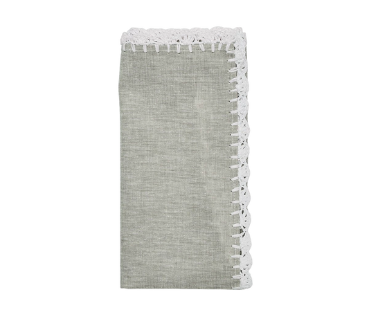 The Shell Edge napkin in gray with hand-crocheted raffia edging in white. A versatile napkin suited for bohemian and rustic-inspired table settings. 100% linen with raffia trimming.