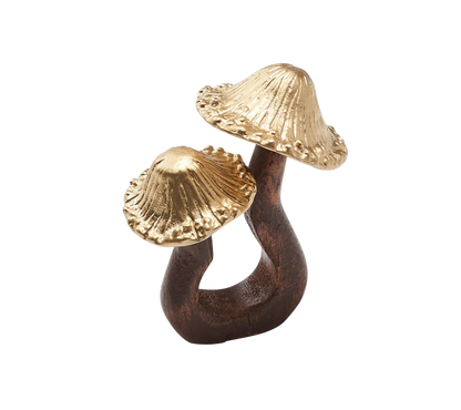 The Sprout Napkin Ring showcases gold-plated metal mushrooms sprouting from a carved wooden base, adding a rustic, organic charm to your fall table setting.