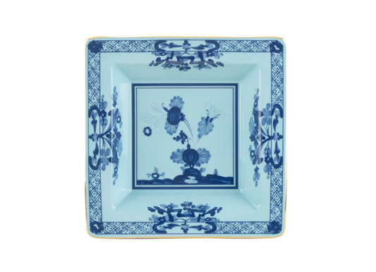 Iris square change tray in porcelain with gold threading from the Oriente Italiano collection. Features a blue carnation floral motif on iris blue porcelain with gold threading along the Antico Doccia shape.