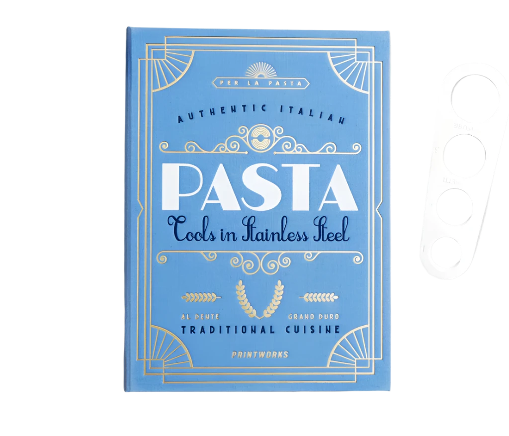 Essential Pasta Kit in an elegant book-like box containing stainless steel spaghetti measurer, serving tongs, and grater—all dishwasher safe for perfect pasta nights.