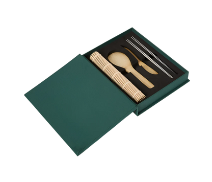 Essential Sushi Kit in a book-like box, featuring a bamboo rice paddle, spreading knife, rolling mat, and 8 chopsticks. Ideal for sushi-making, with all tools dishwasher safe.