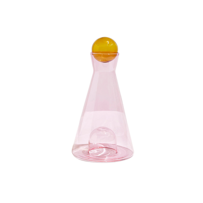 Pink and amber Vice Versa Carafe with a sculptural sphere that can rest in the glass-blown mouth or base, perfect as a centerpiece or stylish serving vessel.