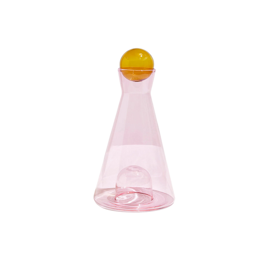 Pink and amber Vice Versa Carafe with a sculptural sphere that can rest in the glass-blown mouth or base, perfect as a centerpiece or stylish serving vessel.