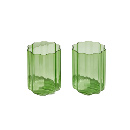 Set of two green Wave Glasses with a rippled design, adding a playful yet elegant touch to any drink or occasion.